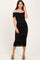 woman wearing a black off-the-shoulder bodycon midi dress with ruching details and strappy black heels
