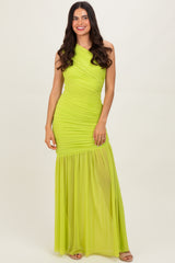 woman wearing a bright lime green one-shoulder gown with ruching and a sheer skirt detail