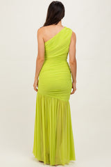 woman wearing a one-shoulder bright lime green evening gown with ruching and a flowy skirt