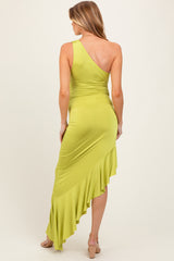 woman wearing a lime green one-shoulder maternity dress with a ruffled hem