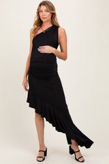 woman wearing a black one-shoulder maternity dress with ruffle detail and baby bump visible