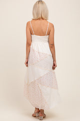 woman wearing a long floral patchwork maternity maxi dress with thin straps and a smocked bodice