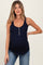 woman wearing a navy blue maternity tank top with button details and a visible baby bump