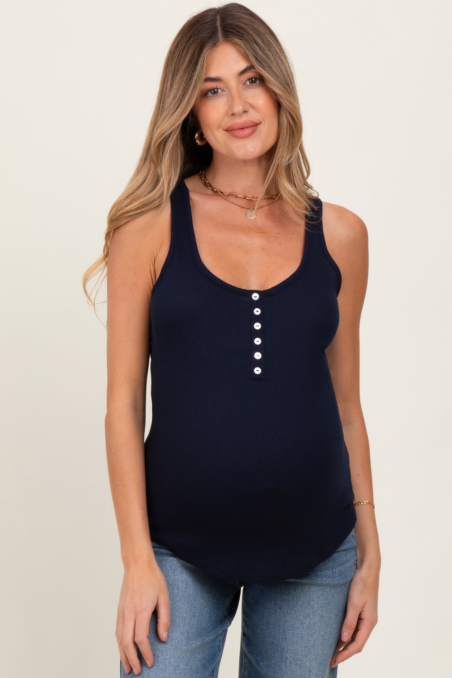 woman wearing a navy blue maternity tank top with buttons and a visible baby bump