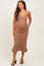 woman wearing a brown textured midi maternity dress with a ruffled hem and adjustable straps, showing her baby bump