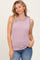 woman wearing a light pink sleeveless ribbed top with blue accents and blue jeans