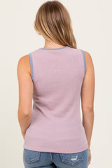 woman wearing a lavender ribbed sleeveless top with blue trim, viewed from the back