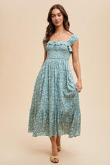 woman wearing a light blue floral midi dress with ruffled sleeves and a fitted bodice