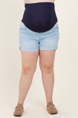 woman wearing a navy blue high-waisted maternity shorts with a visible baby bump