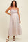 woman wearing a floral maternity maxi dress with a fitted bodice and flowing skirt, showcasing her baby bump