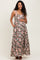 woman wearing a brown floral maternity maxi dress with adjustable straps and a baby bump.