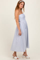 woman wearing a blue and white striped strapless midi dress with a fitted bodice and full skirt