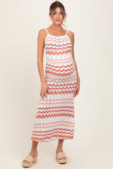 woman wearing a multicolored chevron patterned maternity maxi dress and showing her baby bump