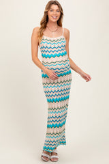 woman wearing a multi-colored zigzag pattern maternity maxi dress and holding her baby bump