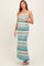 woman wearing a patterned maternity maxi dress with a chevron design and a visible baby bump