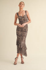 woman wearing a fitted leopard print midi dress with ruffle hem and thick straps, posing against a neutral background