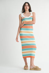 woman wearing a multicolored striped ribbed knit midi dress with white straps and tan slip-on sandals
