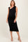 woman wearing a black ruched maternity dress with one shoulder and a visible baby bump