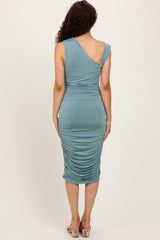 woman wearing a fitted teal ruched midi dress with a one-shoulder design, shown from the back