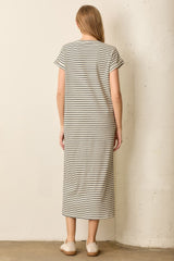 woman wearing a striped midi dress with short sleeves, seen from the back, styled with simple slip-on shoes