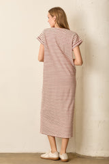 woman wearing a striped pink and white maxi dress with short sleeves and a relaxed fit
