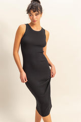 woman wearing a black ribbed midi dress with a sleeveless design and fitted silhouette