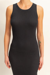 woman wearing a black ribbed sleeveless bodycon dress