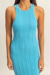 woman wearing a sleeveless ribbed turquoise dress with a fitted silhouette