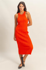 woman wearing a sleeveless ribbed midi dress in bright orange with a fitted silhouette