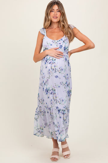 woman wearing a lilac floral maternity maxi dress and holding her baby bump