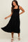 woman wearing a black maternity midi dress with smocked bodice and ruffled straps, showing her baby bump