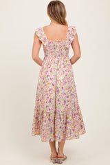 woman wearing a back view of a floral midi dress with ruffle straps and a smocked bodice