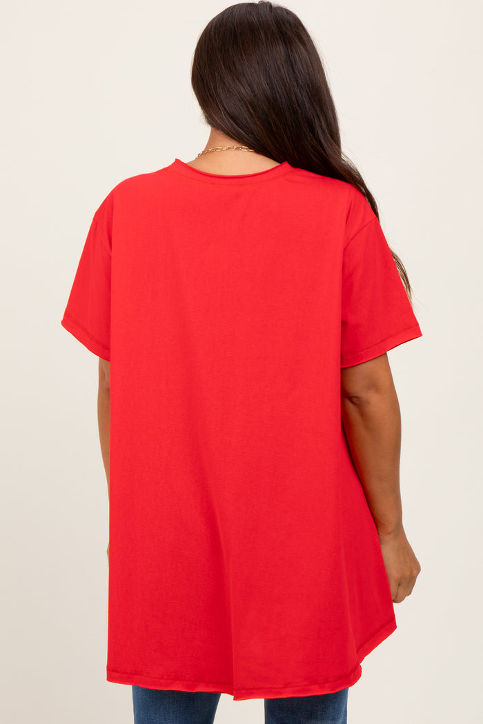 woman wearing a loose-fitting red maternity top, viewed from the back