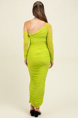 woman wearing a bright green one-shoulder maternity dress with long ruched sleeves, showcasing a fitted silhouette