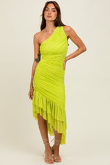 woman wearing a vibrant neon green one-shoulder dress with ruched detailing and a ruffled hem