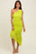 woman wearing a bright lime green one-shoulder midi dress with ruching and a ruffled hem detail