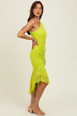 woman wearing a bright yellow one-shoulder ruched dress with a layered hem and strappy nude heels