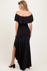 woman wearing a black off-the-shoulder maternity dress with a flowing hem and back detail
