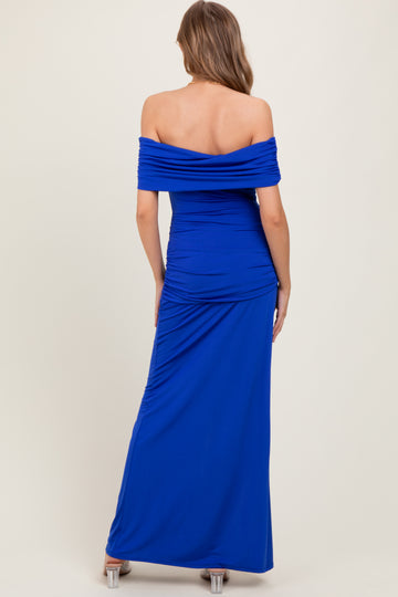 woman wearing a royal blue off-the-shoulder maxi dress with ruching details on the back
