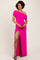 woman wearing a hot pink off-shoulder dress with ruching and a high split, standing and smiling