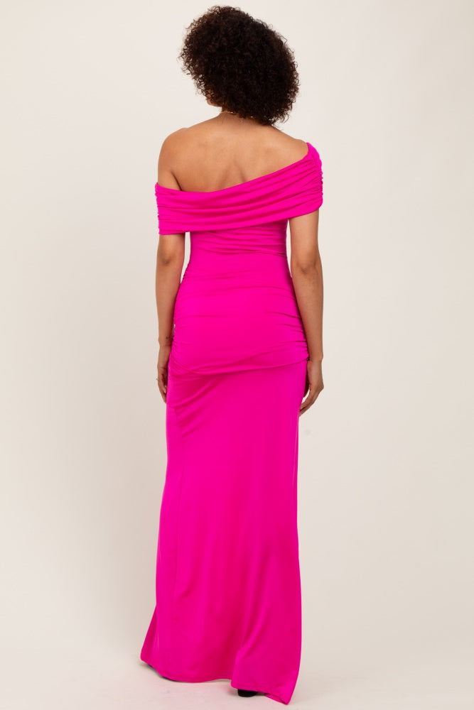 woman wearing a vibrant pink off-shoulder maxi dress with ruched details and a fitted silhouette from the back