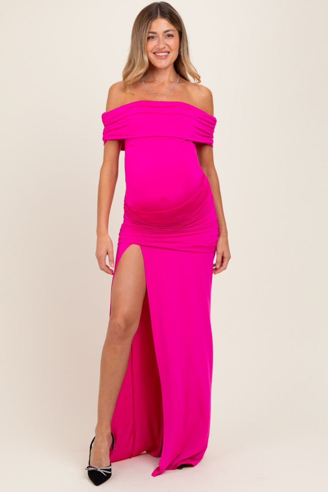 woman wearing a bright pink off-the-shoulder maternity gown with a thigh-high slit and a visible baby bump