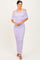 woman wearing a lavender off-shoulder ruched maxi dress with a fitted silhouette and stylish neckline