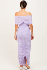 woman wearing a lilac off-the-shoulder ruched maxi dress with a thigh-high slit and back detailing