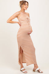 woman wearing a striped maternity maxi dress with a tie front and side slits, showing her baby bump