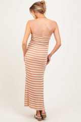 woman wearing a striped maternity maxi dress in beige and white, showing her back and a baby bump