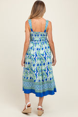 woman wearing a blue and green patterned maternity maxi dress with a smocked back and wide straps