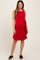 woman wearing a red maternity dress with a side tie detail and a flattering silhouette, styled with black sandals