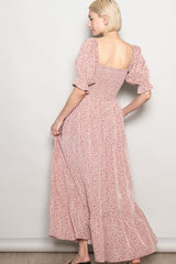 woman wearing a pink floral maxi dress with puff sleeves and a square neckline, shown from the back