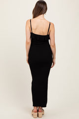 woman wearing a black maternity maxi dress with adjustable straps and ruffle details, showing her back
